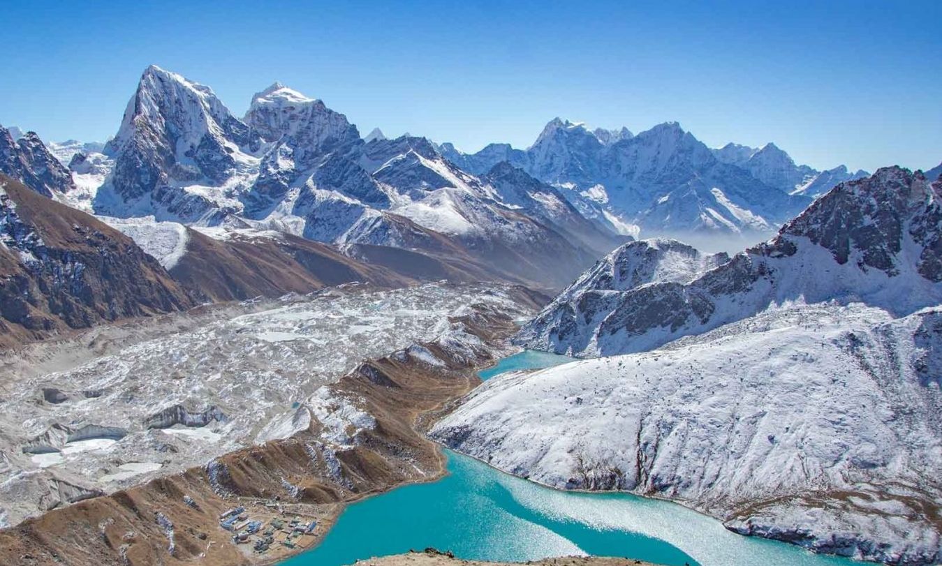 Navigating rugged Himalayan terrain with towering peaks on the Manaslu Three Passes Trek.