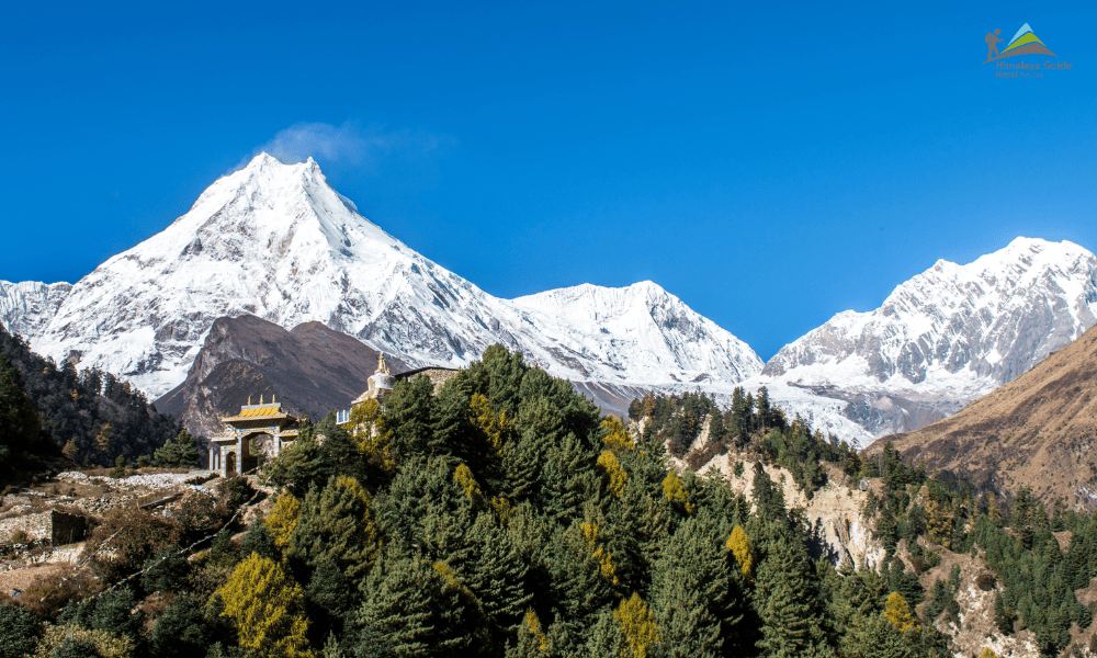 Snow capped peaks and traditional Tibetan villages on the Manaslu Nar Phu Valley Trek in Nepal.