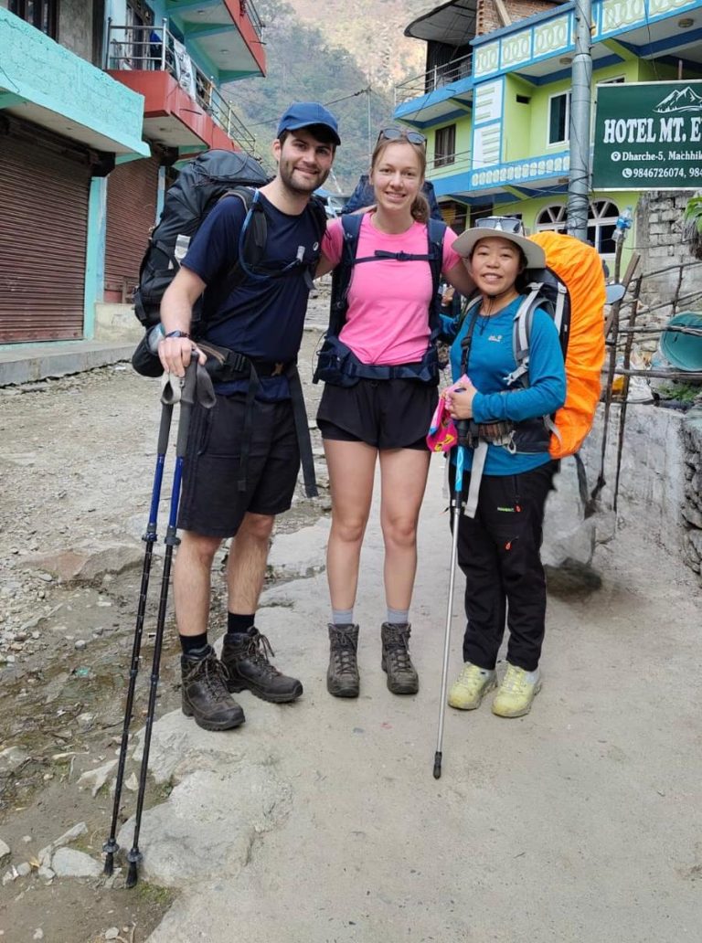 Female trekking guide with clients on Manaslu Circuit Trek in Machhakhola village Nepal